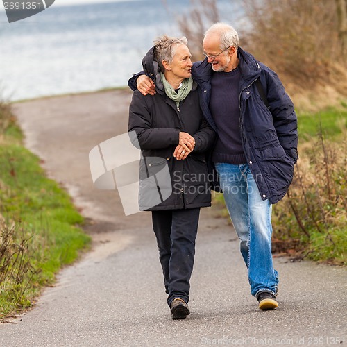 Image of happy mature couple relaxing baltic sea dunes 