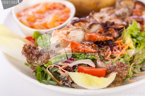 Image of Grilled prawns with endive salad and jacket potato