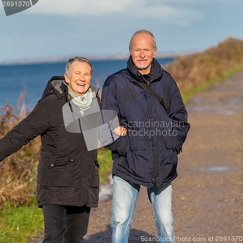 Image of happy mature couple relaxing baltic sea dunes 