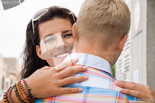 Image of Beautiful radiant woman hugging her boyfriend