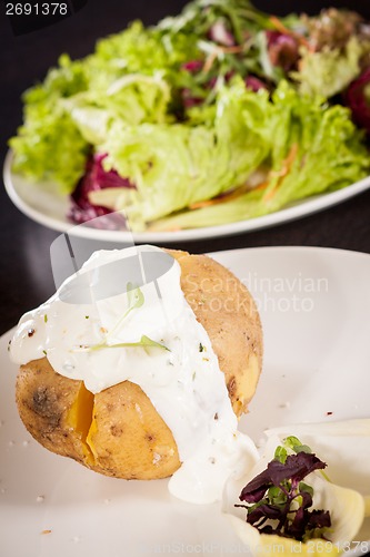 Image of Baked jacket potato with sour cream sauce