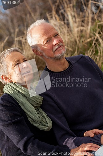 Image of happy senior couple relaxing together in the sunshine