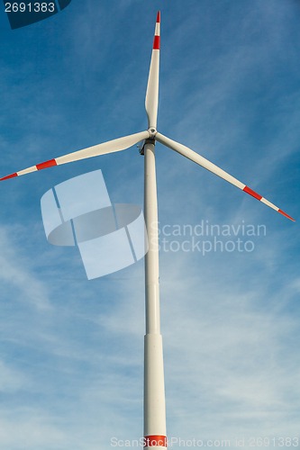 Image of Wind turbine against a blue hazy sky