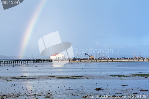 Image of Rainbow over tidal mud flats at the coast