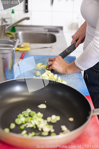 Image of Chef chopping salad ingredients