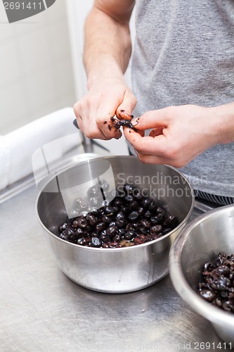 Image of Chef preparing ingredients in a commercial kitchen