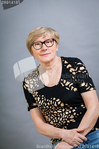 Image of Attractive blond senior woman wearing glasses