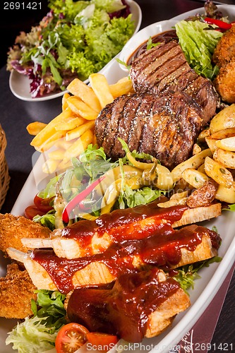 Image of Platter of mixed meats, salad and French fries