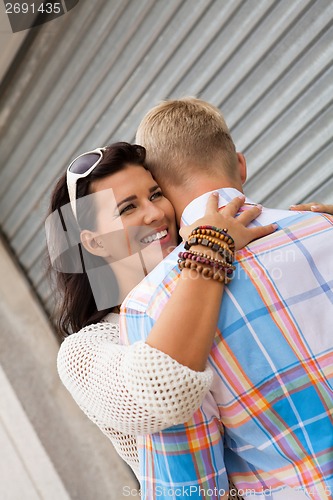 Image of Romantic handsome man hugging his girlfriend