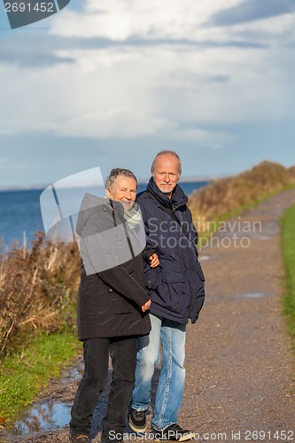 Image of happy mature couple relaxing baltic sea dunes 