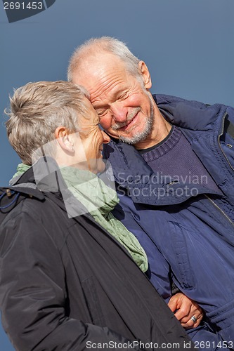 Image of happy elderly senior couple walking on beach