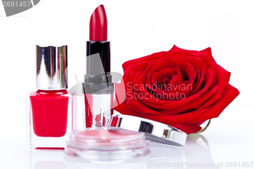 Image of Fashionable cosmetics with a fresh red rose