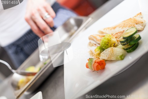 Image of Fried fish fillets and vegetables