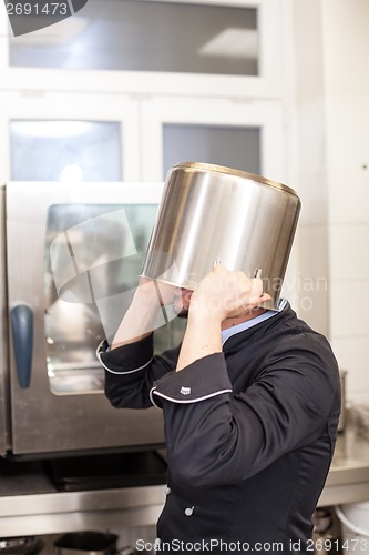 Image of Chef cooking a vegetables stir fry over a hob