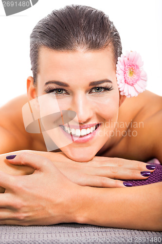 Image of young attractive woman hot stone massage wellness