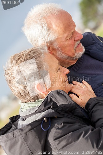 Image of happy elderly senior couple walking on beach