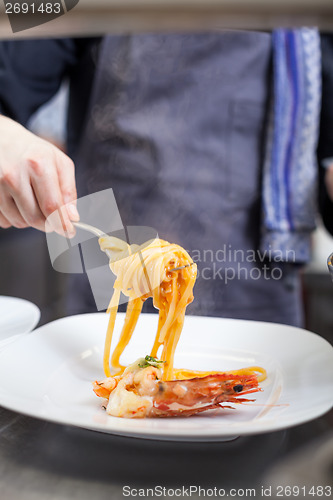 Image of Chef plating up seafood pasta