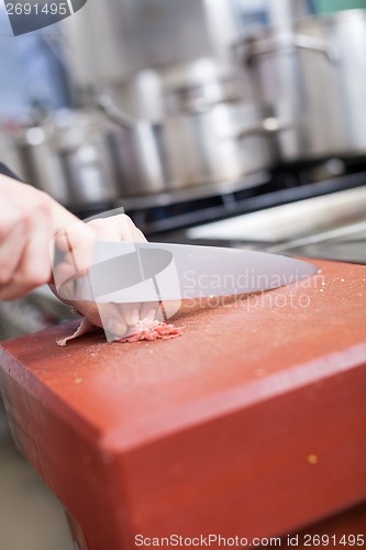 Image of Chef or butcher dicing meat