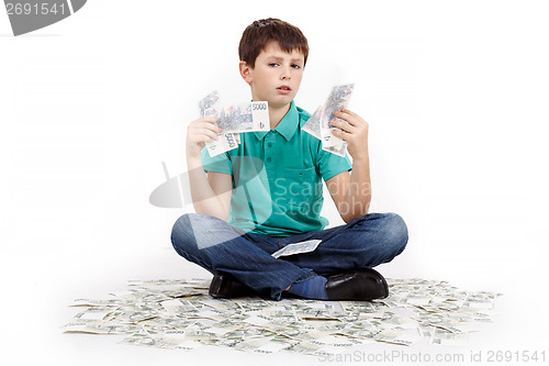 Image of boy sitting on money