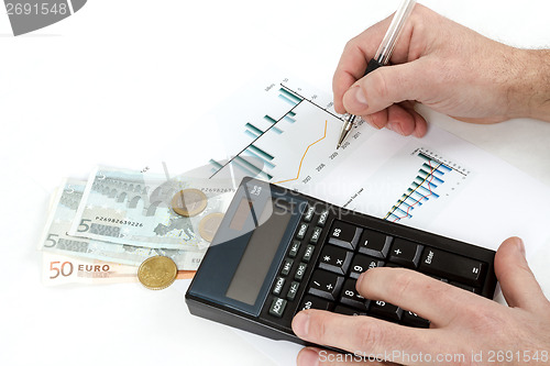 Image of men analyzing business graph with glasses in the background