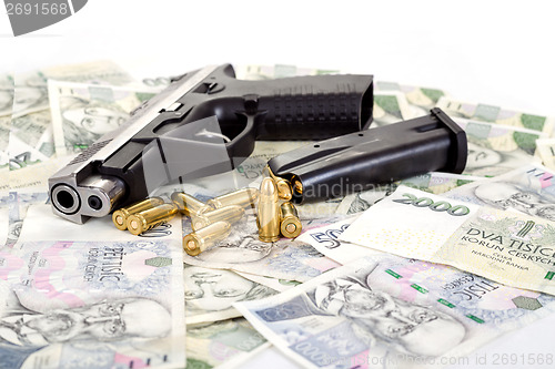 Image of gun with bullet on czech banknotes