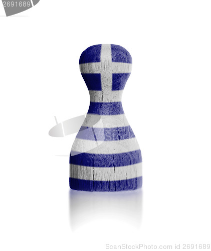 Image of Wooden pawn with a painting of a flag