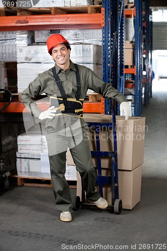 Image of Foreman With Handtruck Loading Cardboard Boxes