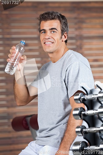 Image of Happy Man Drinking Water From Bottle At Health Club