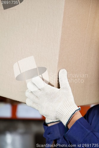 Image of Foreman's Hands Lifting Cardboard Box