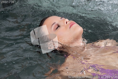 Image of Woman lying in bath