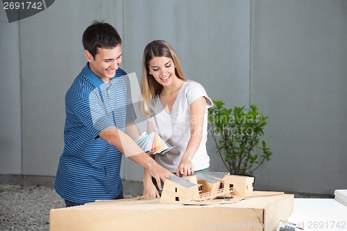 Image of Couple Selecting Colors For Model House
