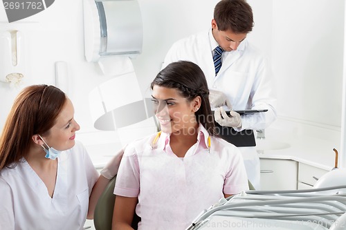 Image of Nurse Communicating With Female Patient At Dental Clinic