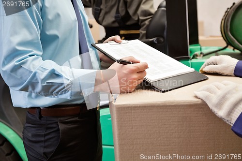 Image of Supervisor Showing Clipboard To Foreman