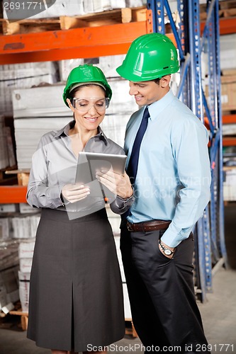 Image of Female Supervisor And Colleague Using Digital Tablet
