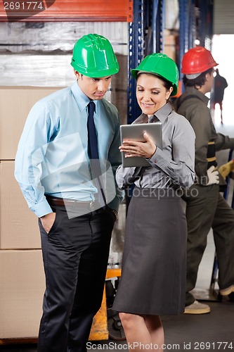 Image of Supervisors Using Digital Tablet At Warehouse