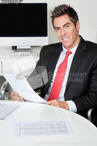 Image of Happy Businessman Holding Document