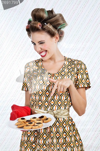 Image of Woman Winks As She Holds Plate Of Cookies