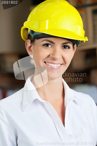 Image of Female Supervisor Wearing Hardhat At Warehouse