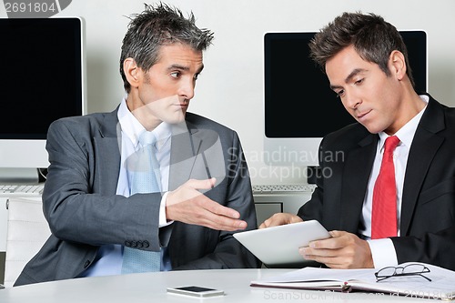 Image of Businessmen Using Digital Tablet At Desk