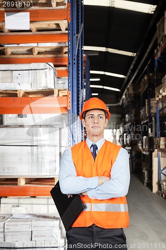 Image of Male Supervisor With Arms Crossed At Warehouse