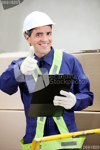 Image of Supervisor With Clipboard Gesturing Thumbs Up