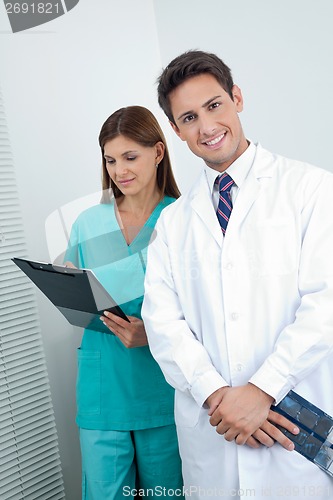 Image of Doctor And Dental Nurse With Reports