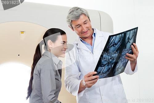 Image of Radiologist Showing X-ray Report To Patient