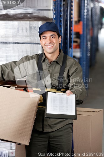 Image of Male Supervisor With Clipboard And Cardboard Box