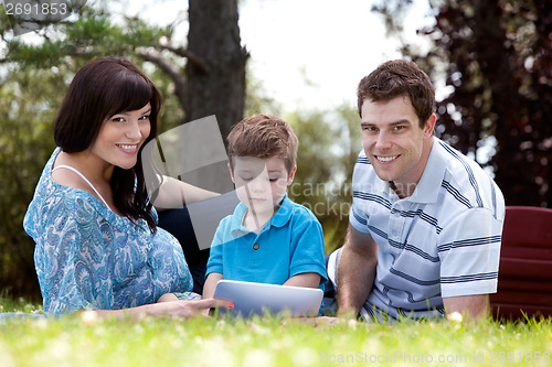 Image of Young Boy With Parents in Park