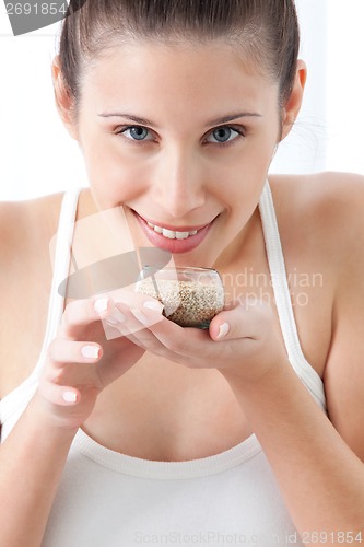 Image of Young Woman holding Sesame Seed