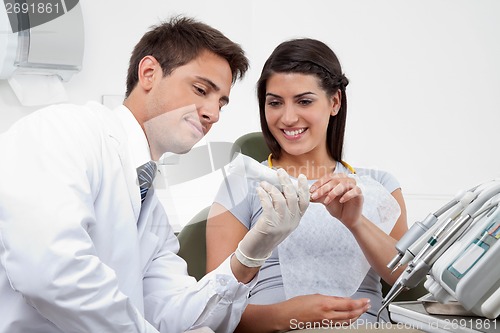 Image of Dentist Prescribing Tooth Paste To Patient