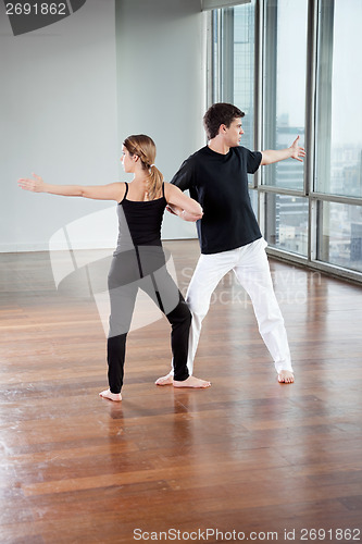 Image of Yoga Partners Exercising At Gym