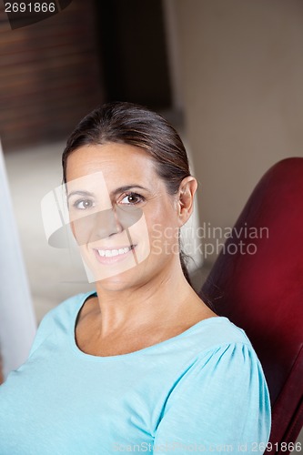 Image of Happy Woman Sitting In Chair