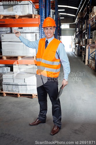 Image of Confident Supervisor Showing Stock On Shelves